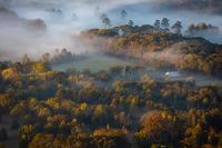 Aerial photo of a foggy farm at sunrise