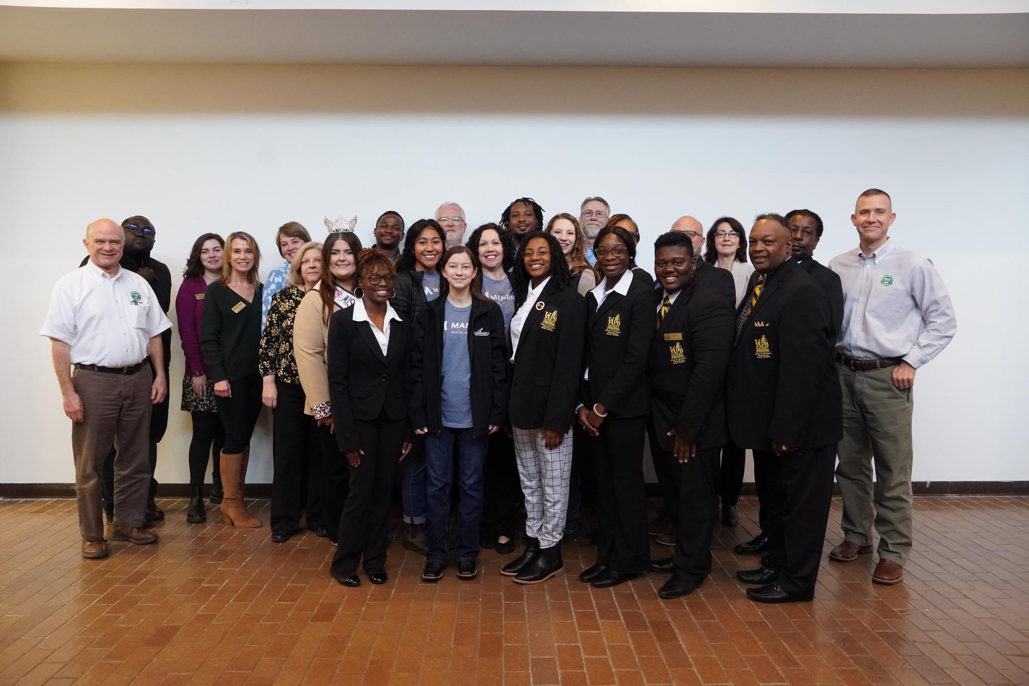 25 people posing for photo. College students in the Minorities in Ag, Natural Resources & Related Services organization are in front.