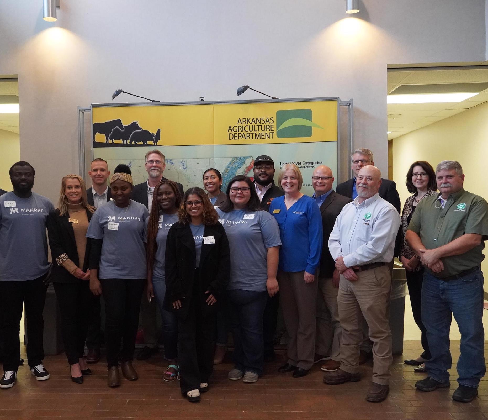 11 people posing for photo. College students in the Minorities in Ag, Natural Resources & Related Services organization are in front.