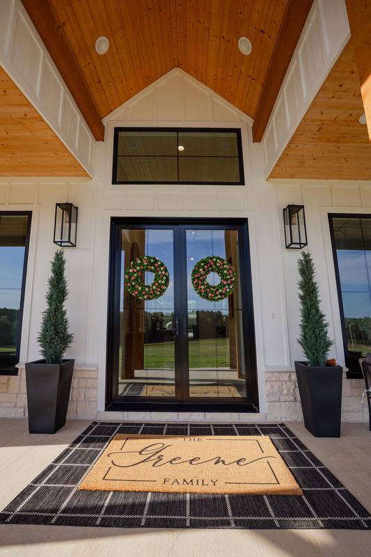 Greene family entryway/portico with large glass double doors and transom window