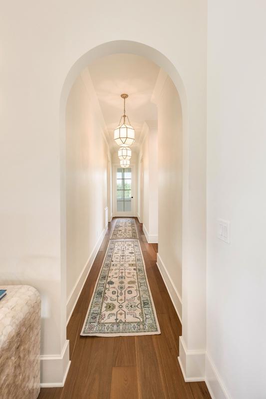 Arched doorways throughout the home soften modern lines and create a timeless architectural feel. 