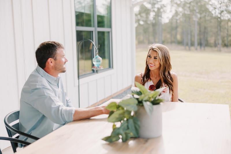 Krystal and Marcus Greene sit at an outdoor table talking