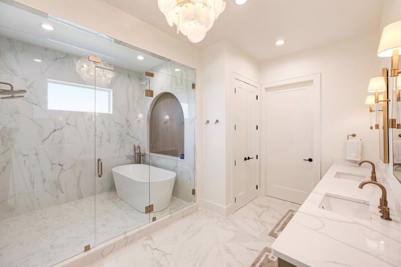 The master bath combines luxury and function with a spacious glass-enclosed wet room featuring both a soaking tub and walk-in shower.  