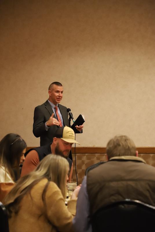 Man speaking in front of group