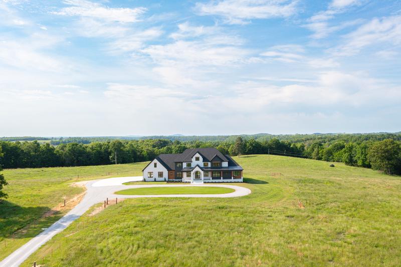 Aerial view of custom-built home in rural western Arkansas. Searcy County home in the country. Home financing for rural home Arkansas. 