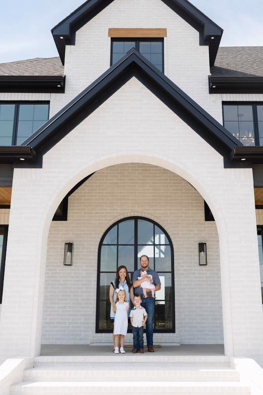 The Branscum family in front of their custom built rural home. Home inspiration. Modern rural home.