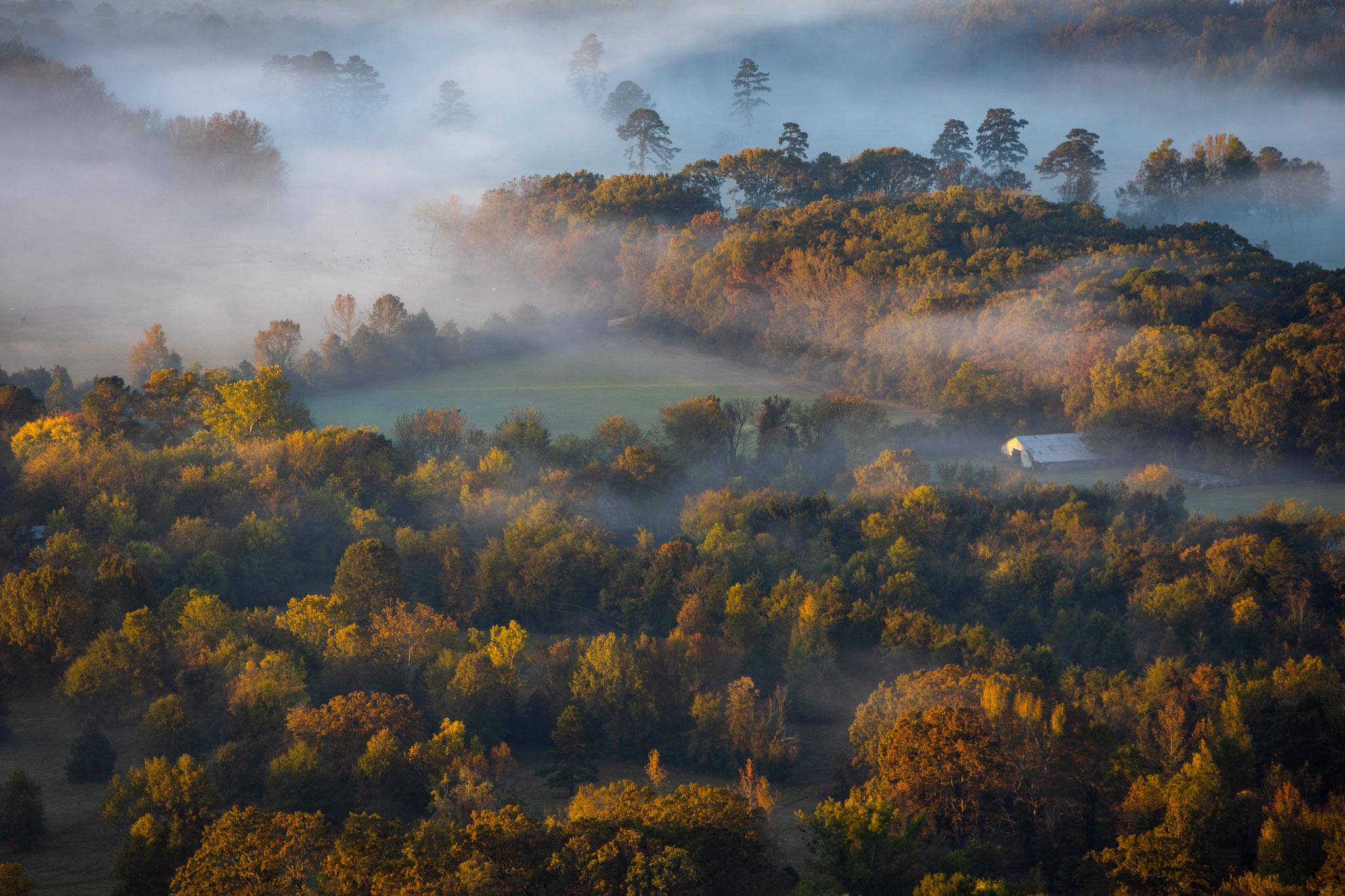 Aerial photo of a foggy farm at sunrise