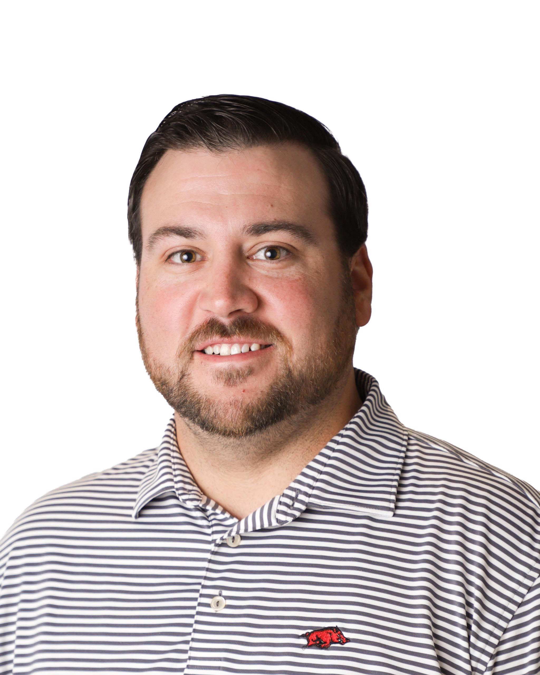 Headshot of a man in striped polo shirt
