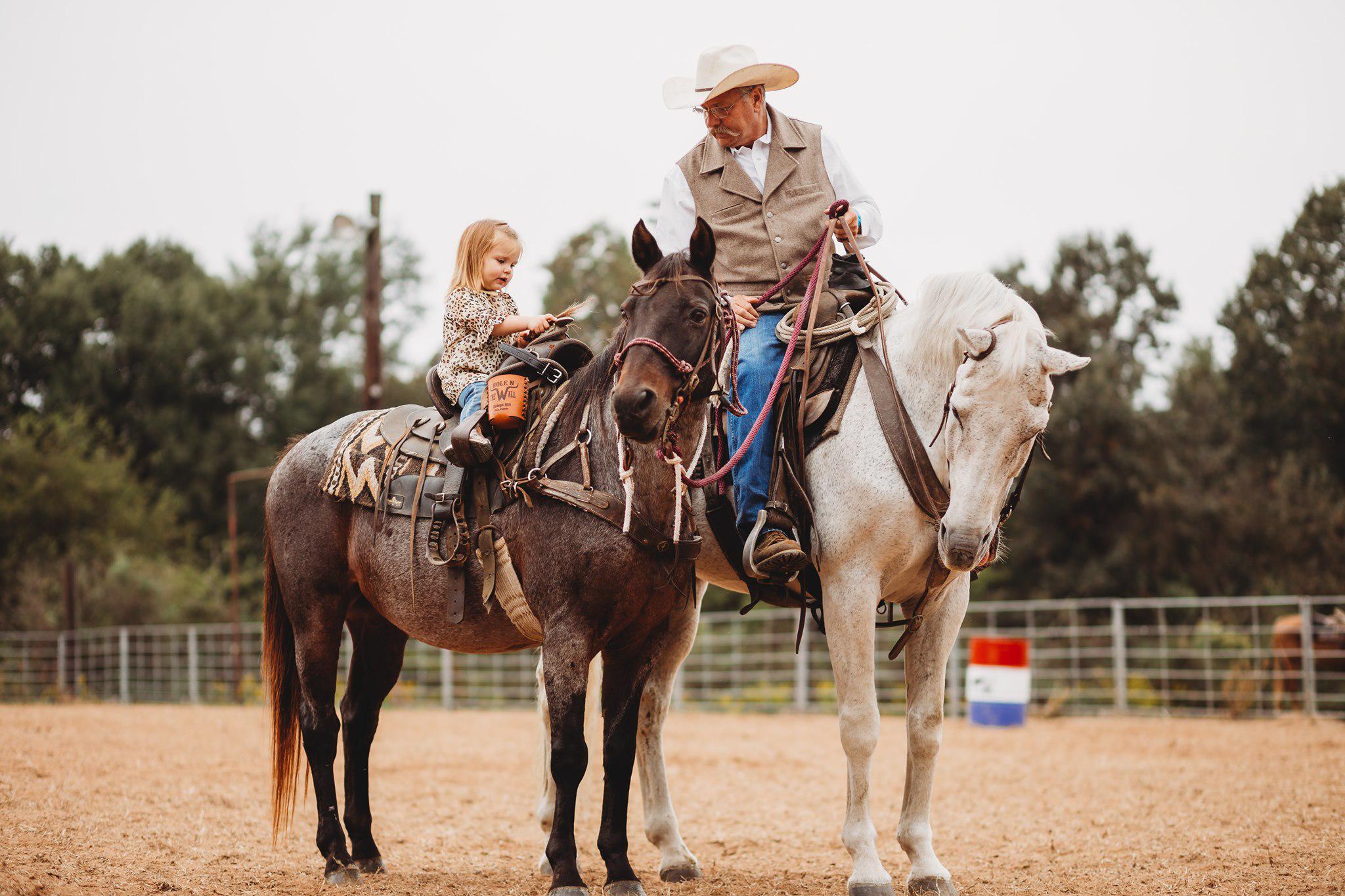 Grandpa and granddaughter on horseback