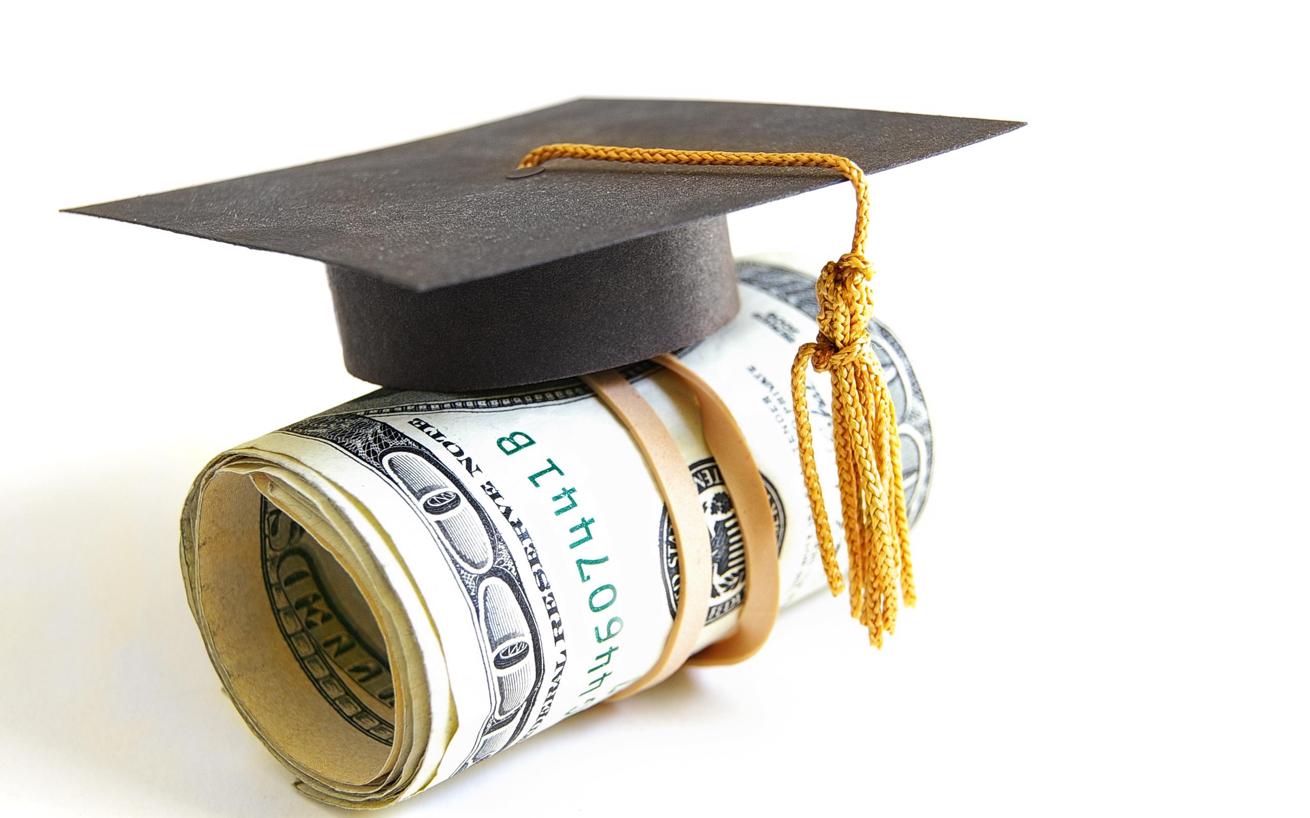 Roll of money with graduation cap and tassel