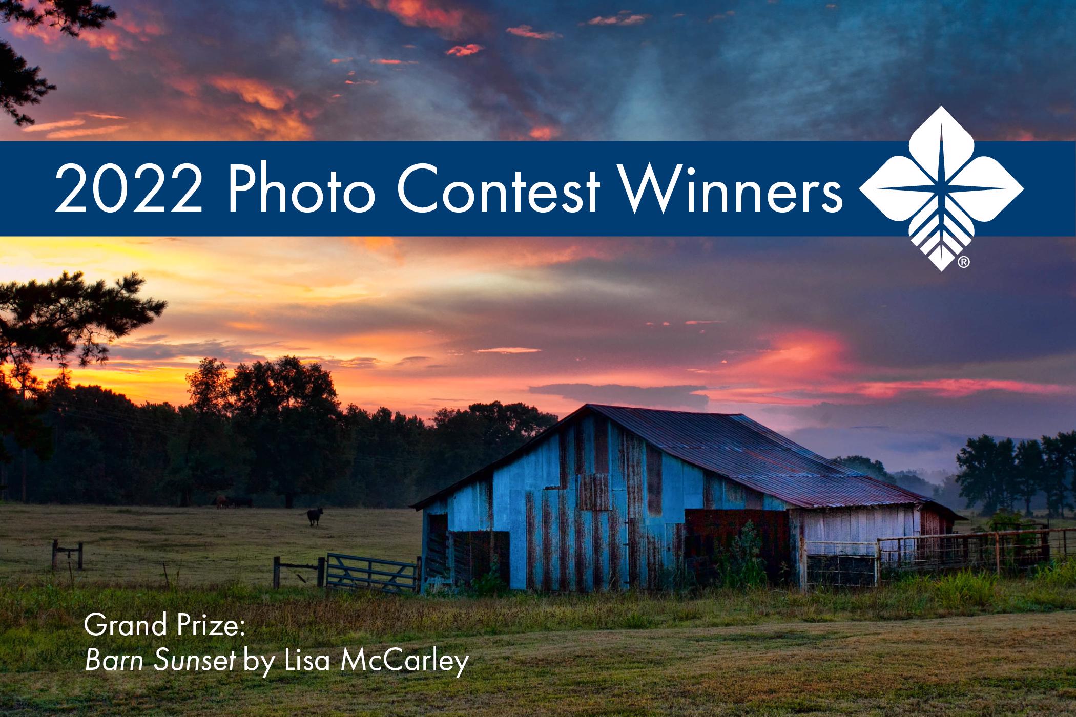 Rusty barn in front of sunset. Top text reads "2022 Photo Contest Winners". Caption reads, "Grand Prize: Barn Sunset by Lisa McCarley"