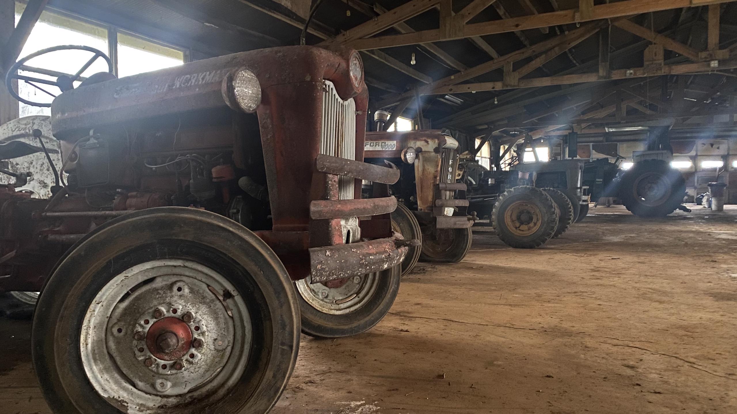 Old tractors in barn.