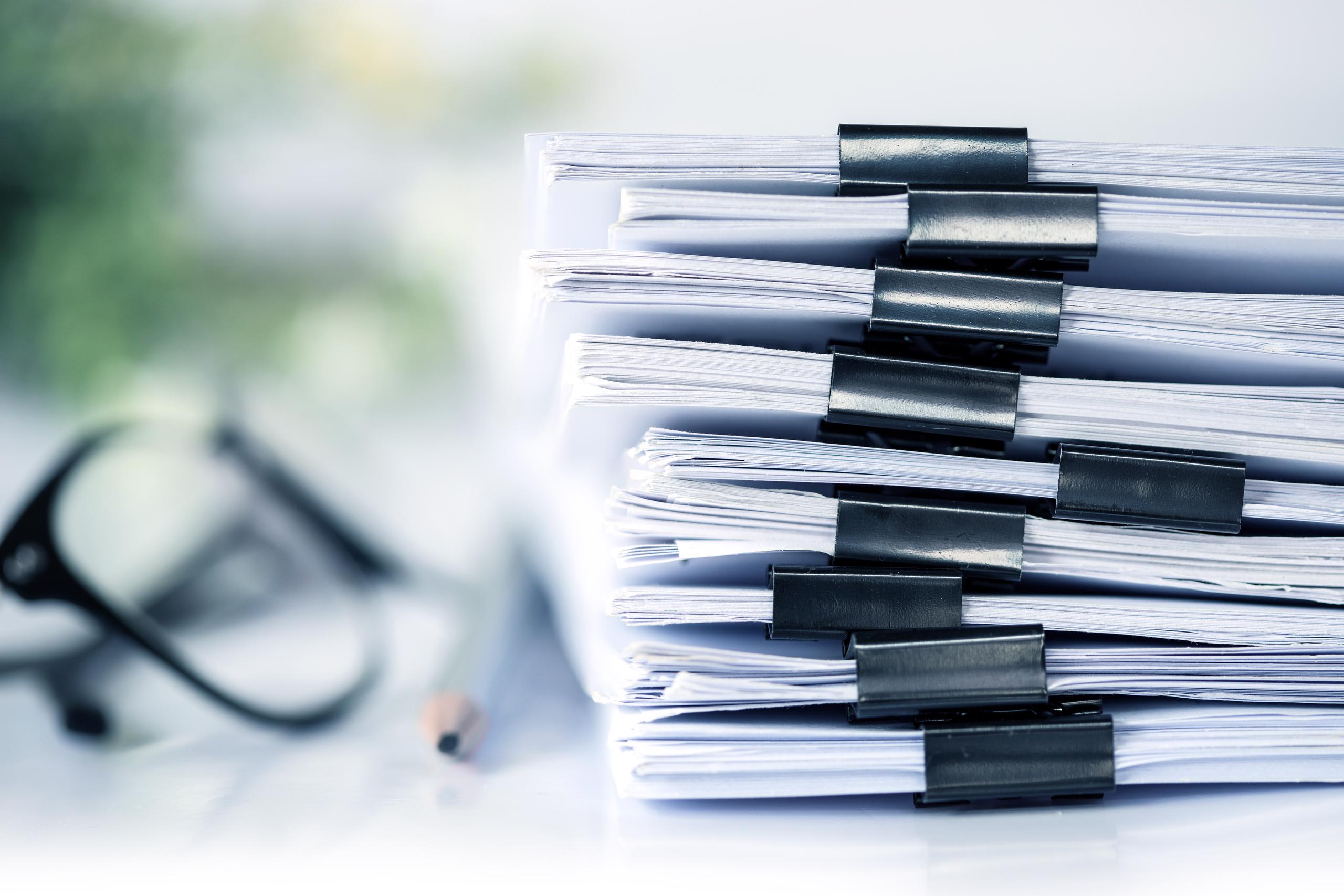 Stack of papers with binder clips, understanding financial documents, loan documents, what to provide when applying for loan